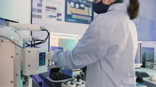Scientist Using Electron Microscope in Laboratory