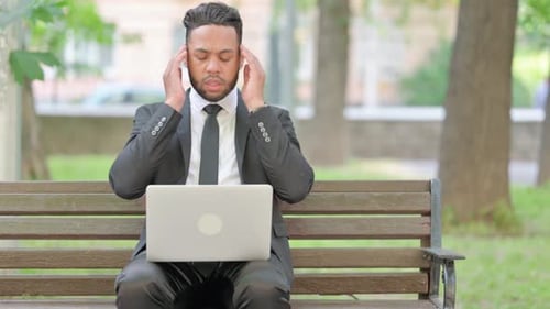 Man Working on Laptop Gets a Headache