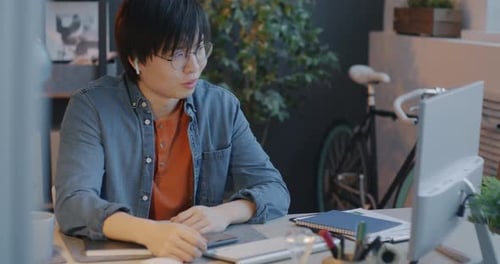 Young Adult Video Calling at Desk in Home Office