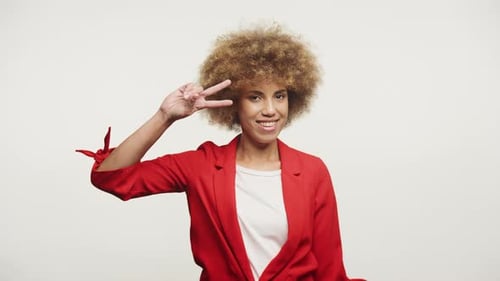 Woman Smiling and Gesturing in Red Blazer