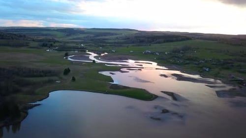 Aerial view of a swampy terrain on a sunset sky background