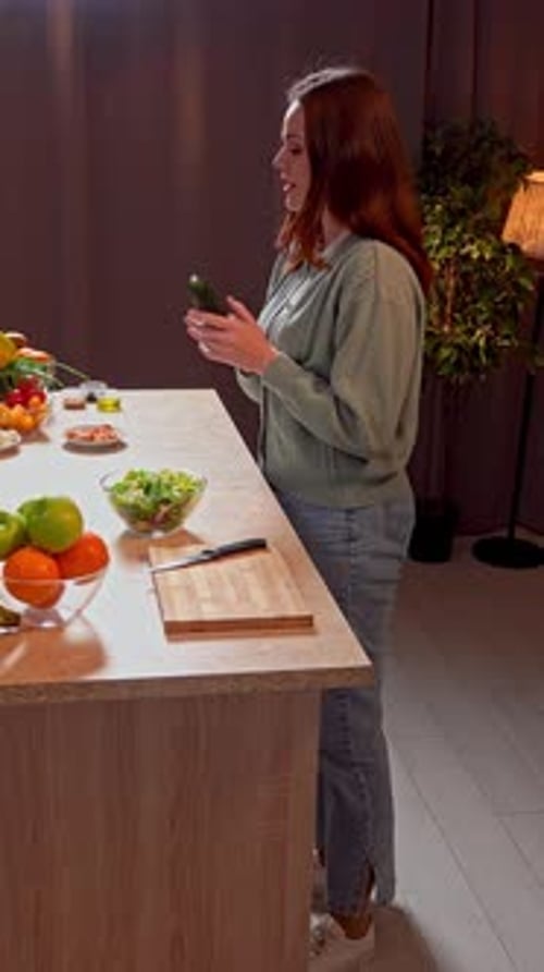 Woman preparing salad in indoor kitchen