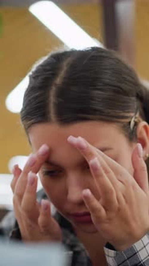 Teen Girl Applying Makeup with Sponge in Mirror