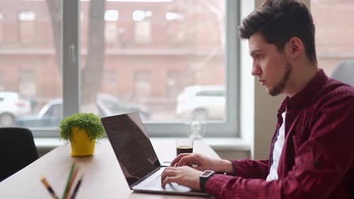 Young Freelancer Man Working with Laptop at Bright Spacious Coworking Alone Creative Designer