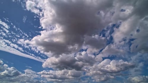 White Clouds Float Across Vivid Blue Sky
