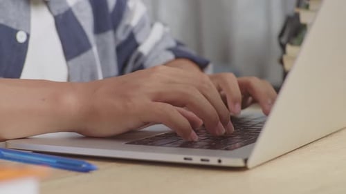 Close Up Shot Of A Male Learner Typing On The Laptop Keyboard