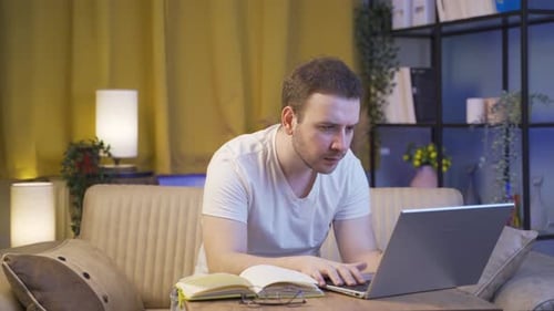Young Adult Using Laptop in Home Interior