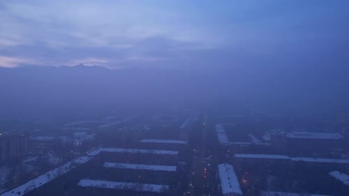 Dawn Over the City in Fog and Smog