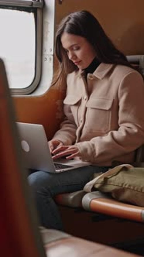 Woman Working on Laptop During Ferry Ride
