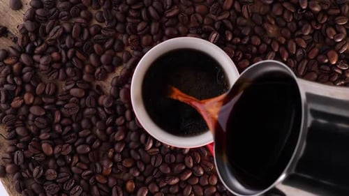 Brewed Coffee is Poured Into an Empty White Coffee Mug Top View