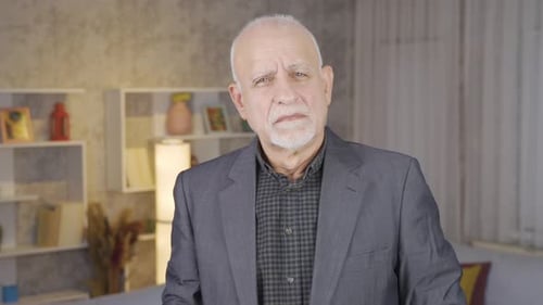 Older Man Adjusts Collar and Smiles