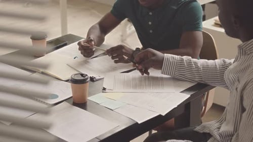 Business Partners Discussing Financial Report in Office