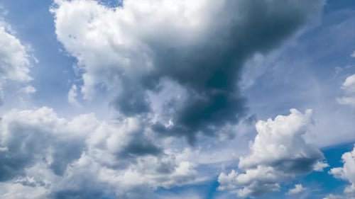 Fluffy clouds transforming at the backdrop of dense cloudscape. Cumulus clouds and spindrift clouds