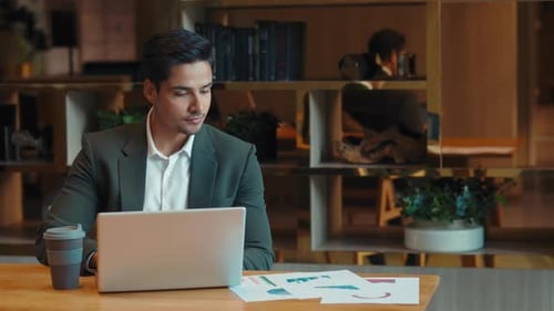 Handsome Man Working on Laptop in Modern Office