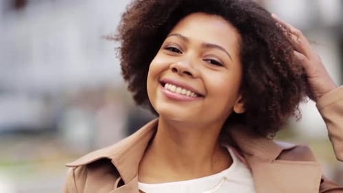 Smiling young woman poses in outdoor urban setting