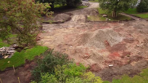 Aerial view of cleared land and construction work in residential neighborhood