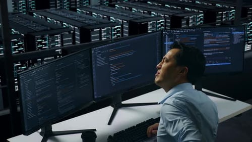 Side View Of Asian Man Developer Having Backache While Write Code In Data Center