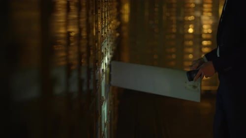 Man Opening Safe Deposit Box at Night