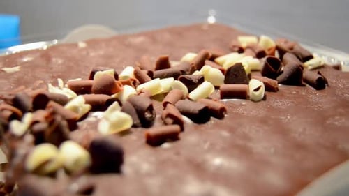 abstract Blurred background shot of rotating cake close up of grated black and white chocolate