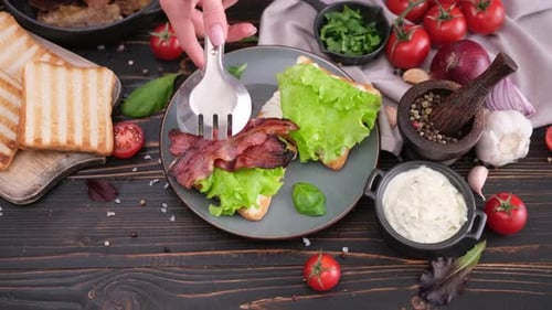Making Delicious Sandwich with Bacon, Lettuce and Tomato