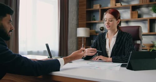 Business woman and business man discussing work issues during meeting at office. Business concept