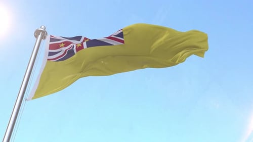 Realistic Niue Flag Waving Against Blue Sky