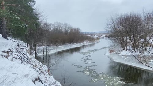 High Bank Winter Drift of Ice on the River A Winter River