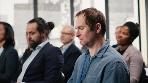 Diverse Audience Applauding Presentation in Bright Modern Venue