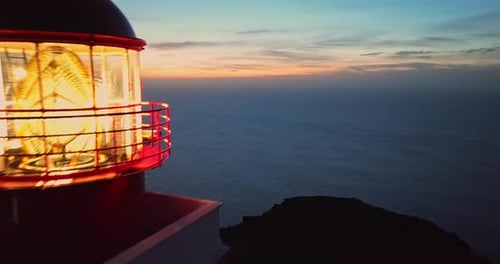 Aerial View to Working Lighthouse at Dusk Time Located on a Picturesque Rock Lighthouse Ponta Do