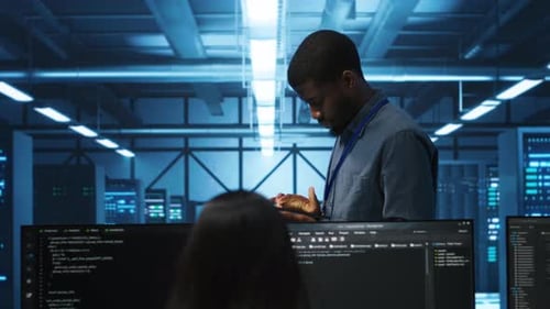 Manager Uses Tablet Supervising Team Programming in Data Center