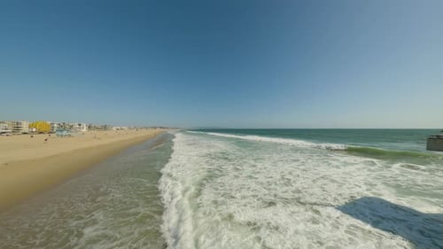 Sandy beach and ocean with waves.