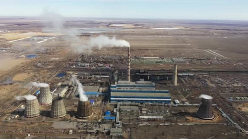 Aerial View of Thermal Power Plant Drone Flies Over Chimney Smoke Pipes and Cooling Towers of