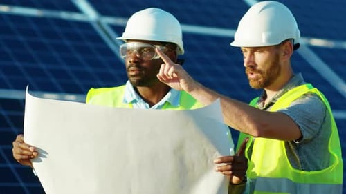 Portrait African American and Caucasian Engineers Stand with Project Plan on the Solar Farm in