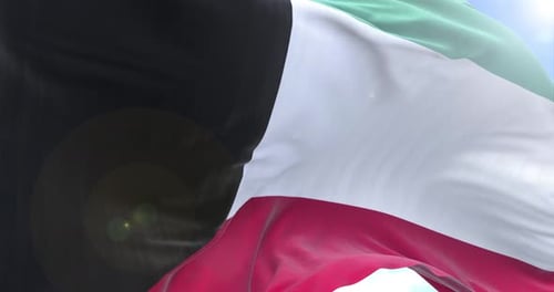 Kuwait Flag Waving in Wind with Blue Sky