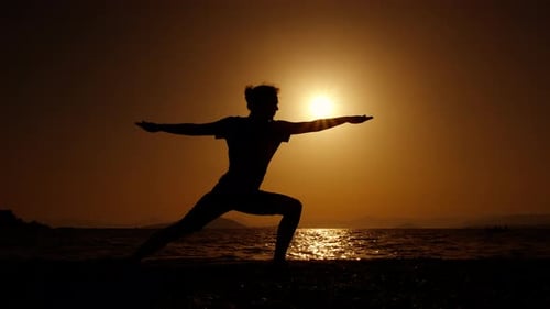 Silhouette Yoga on Beach at Sunset