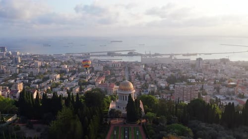 Hot air balloon above Haifa bay and Downtown area at sunrise, Aerial view