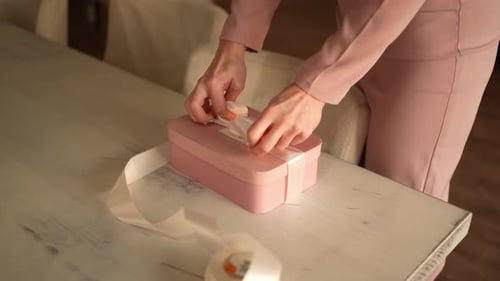 Woman Tying a Bow on Birthday Present