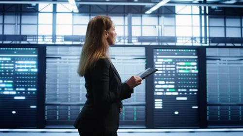 Woman in Data Center Making Sure Rigs are Functioning Optimally