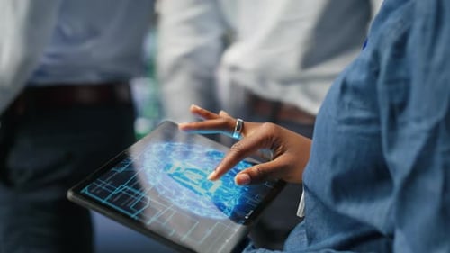 Close Up of Server Farm Admin Using Tablet to Do AI Automatization