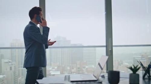Executive Having Phone Conversation in Panoramic Office Manager on Cell Call