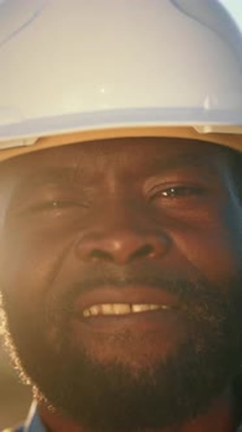 Closeup Portrait of Happy African American Professional Builder Looking at Camera Profession and