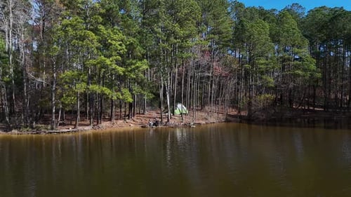 A Lake in a Lush Forest From a Bird's Eye View a Family Has Set Up a Tent in Nature
