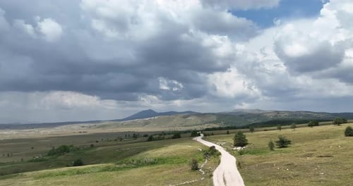 Aerial View of Road in Beautiful Green Fields at Beautiful Sunny Day in Summer