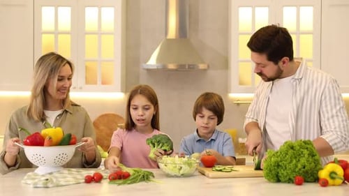 Happy family cooking and having fun together at table in kitchen