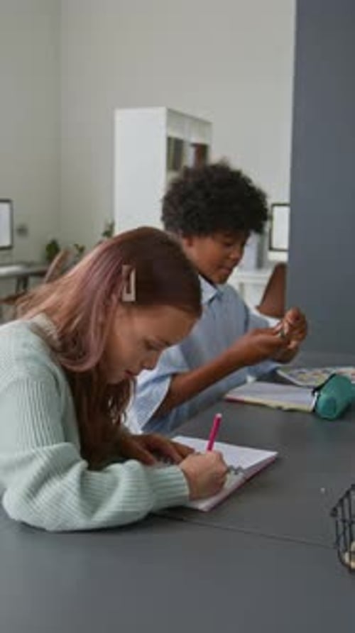 Children Studying Together at a Table Indoors