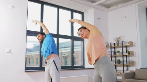 Sport, Fitness, Lifestyle and People Concept - Smiling Man and Woman Exercising