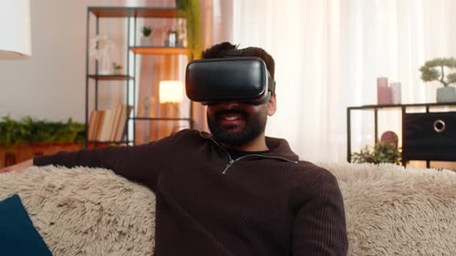 Man Experiencing Virtual Reality Headset on Sofa