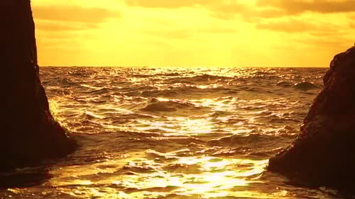 Sea Horizon Line with Waves on Golden Sunset