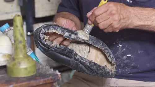 Cobbler Repairing Shoe with Glue Brush