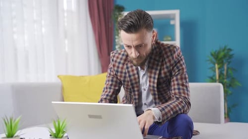 Stressed businessman working from home getting angry and bored.
